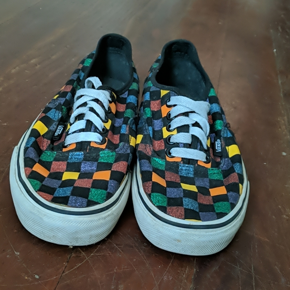 Black and multi-colored checkered Vans